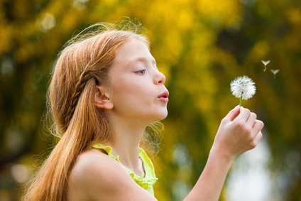 wishes child blowing dandelion,